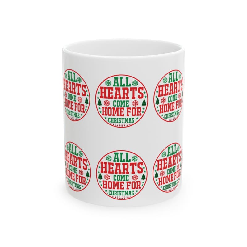 White ceramic mug decorated with repeating red and green circular ’All Hearts Come Home for Christmas’ designs.