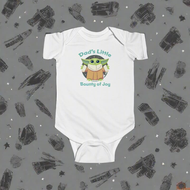 White baby onesie with a cute green alien character and text ’Dad’s Little Bounty of Joy’ printed on the front.