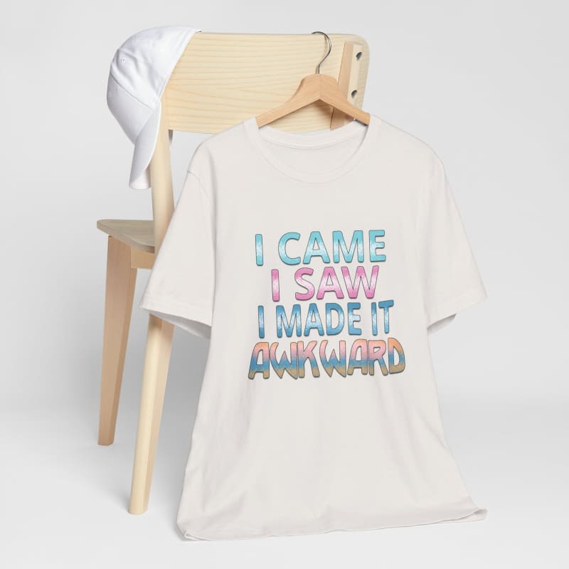 White t-shirt with blue and pink text reading ’I CAME I SAW I MADE IT AWKWARD’