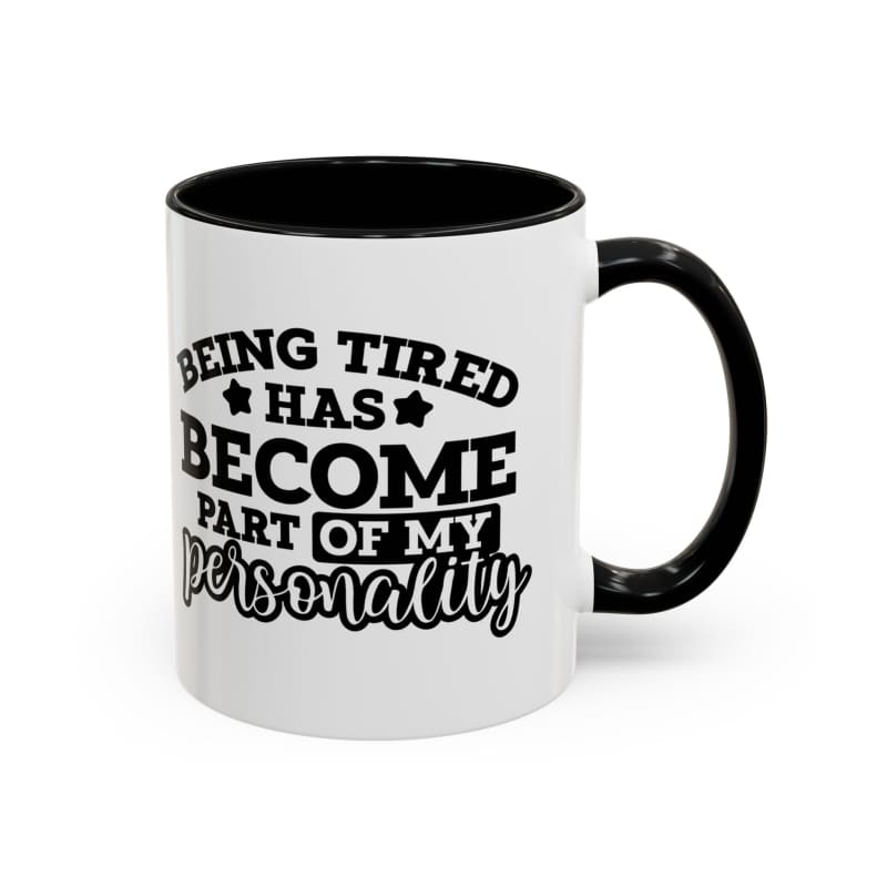 White coffee mug with black interior and black text reading ’Being tired has become part of my personality’