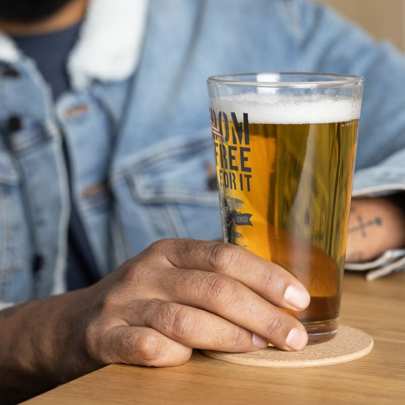 Glass of beer with ’Run Free’ printed on it.