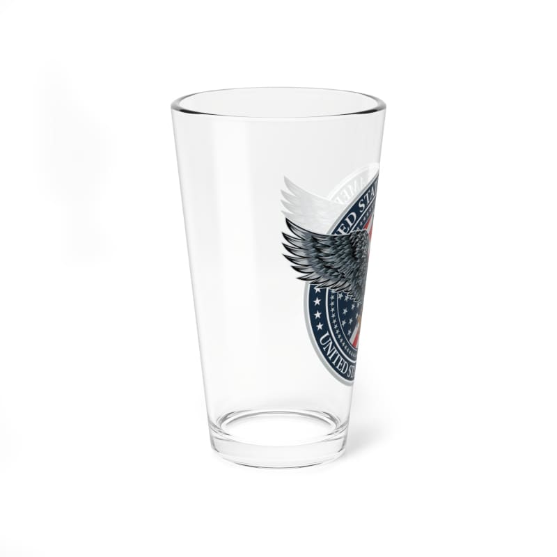 Clear glass pint with a partial eagle logo design visible on one side.