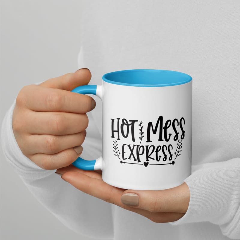 Coffee mug with ’Hot Mess Express’ printed on it, held by hands.