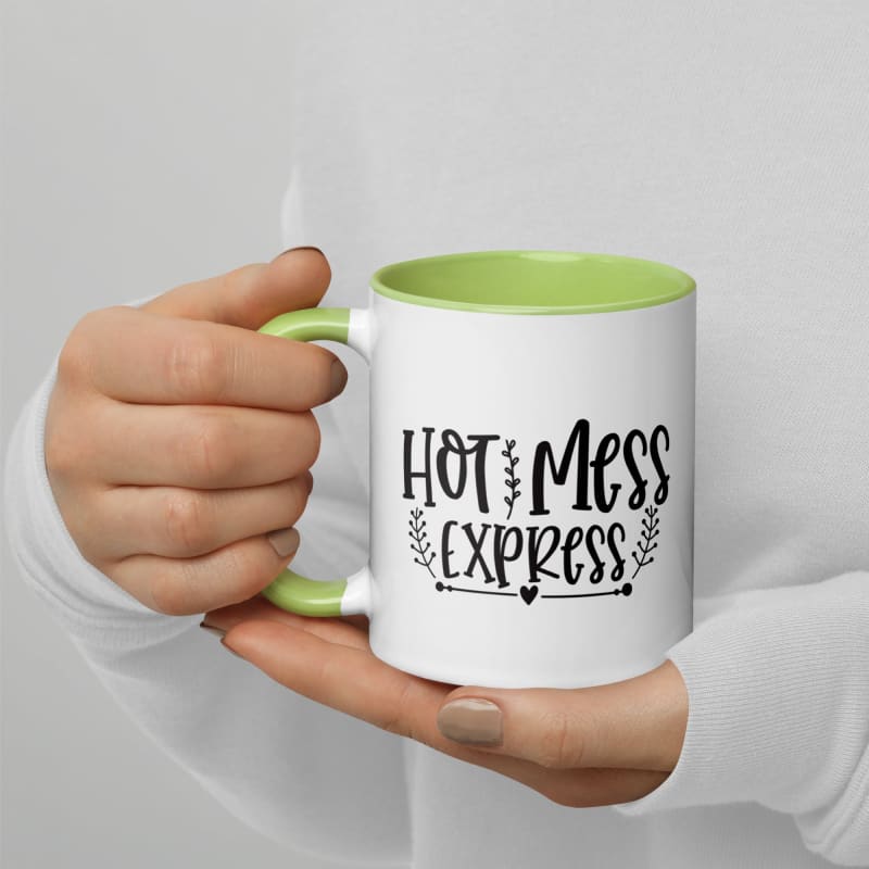 Coffee mug with ’Hot Mess Express’ printed on it, held by hands.