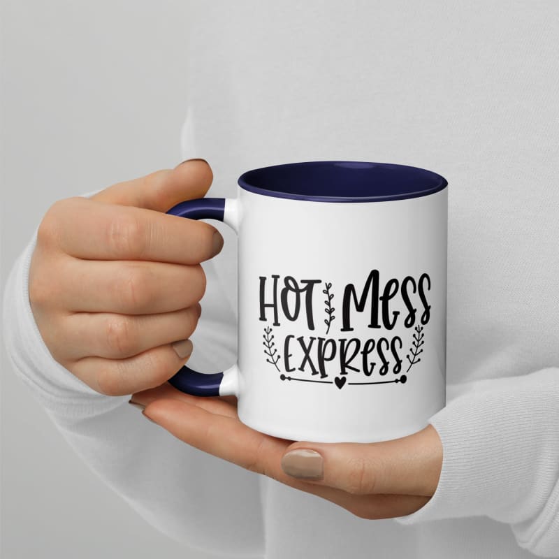 Coffee mug with ’Hot Mess Express’ printed on it, held by hands.