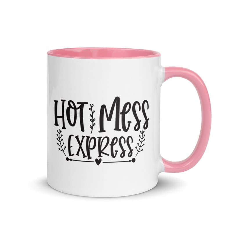 White ceramic mug with pink handle and rim featuring black text reading ’Hot Mess Express’.