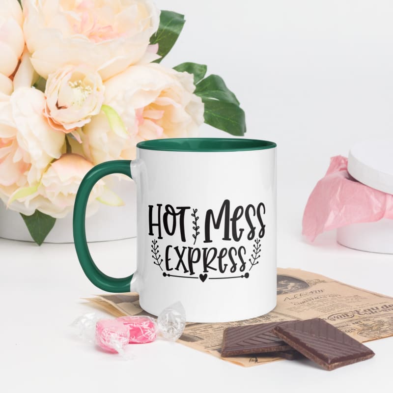 White ceramic mug with green interior and handle, featuring the text ’HOT MESS EXPRESS’ in black lettering.