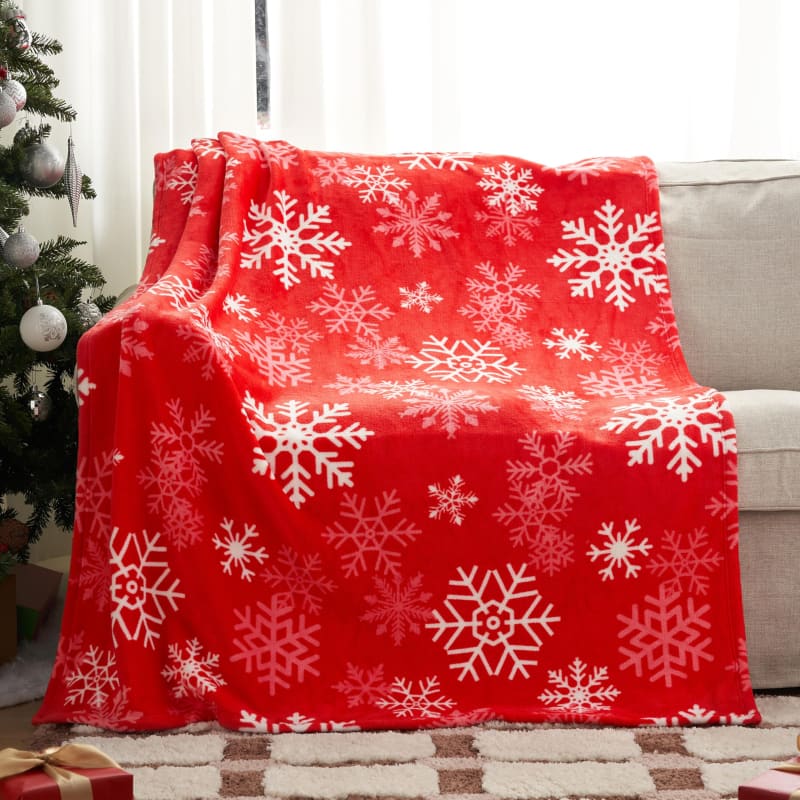 Red fleece blanket with white snowflake pattern.