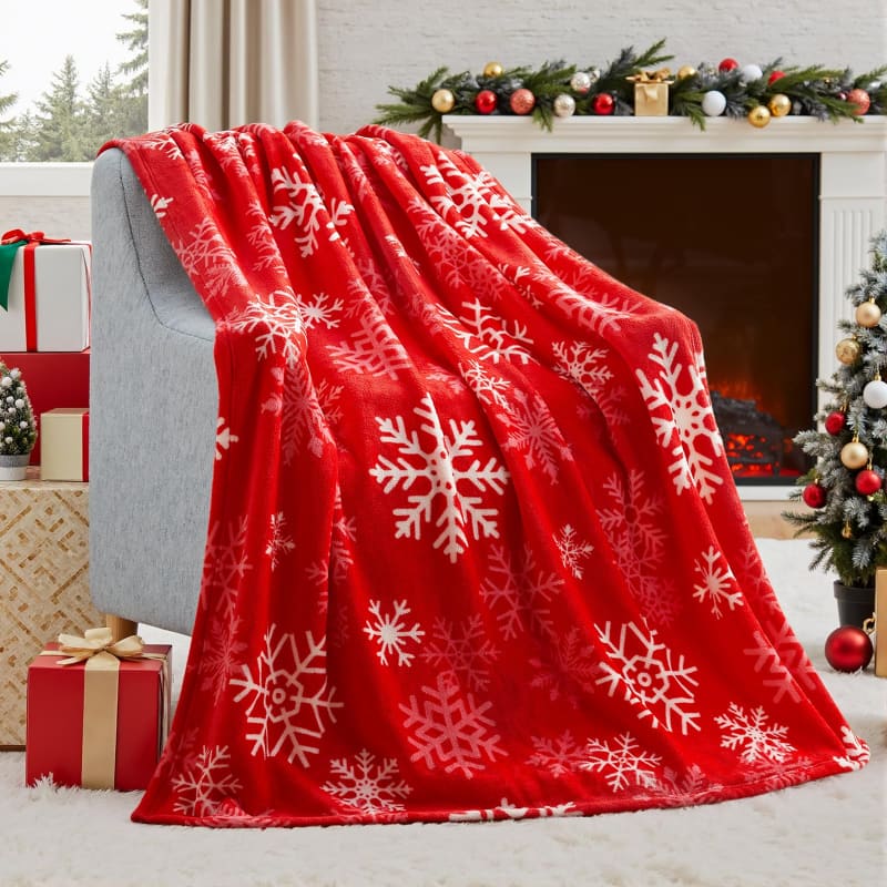 Red fleece blanket with white snowflake pattern.