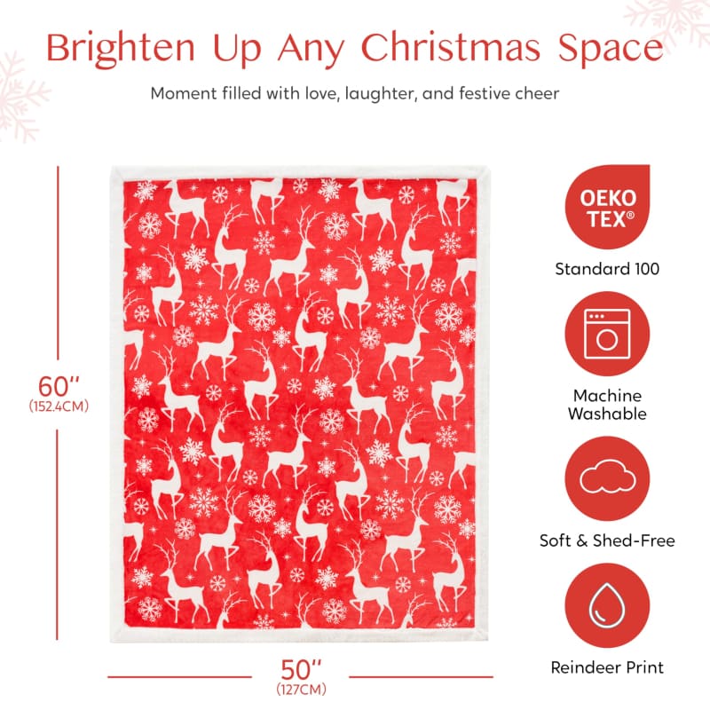 Red and white blanket featuring a reindeer and snowflake pattern.