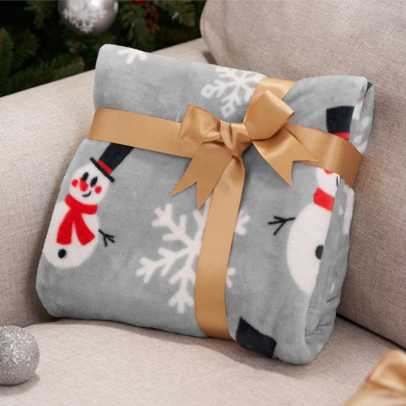 Snowman-patterned fleece blanket tied with a gold bow.