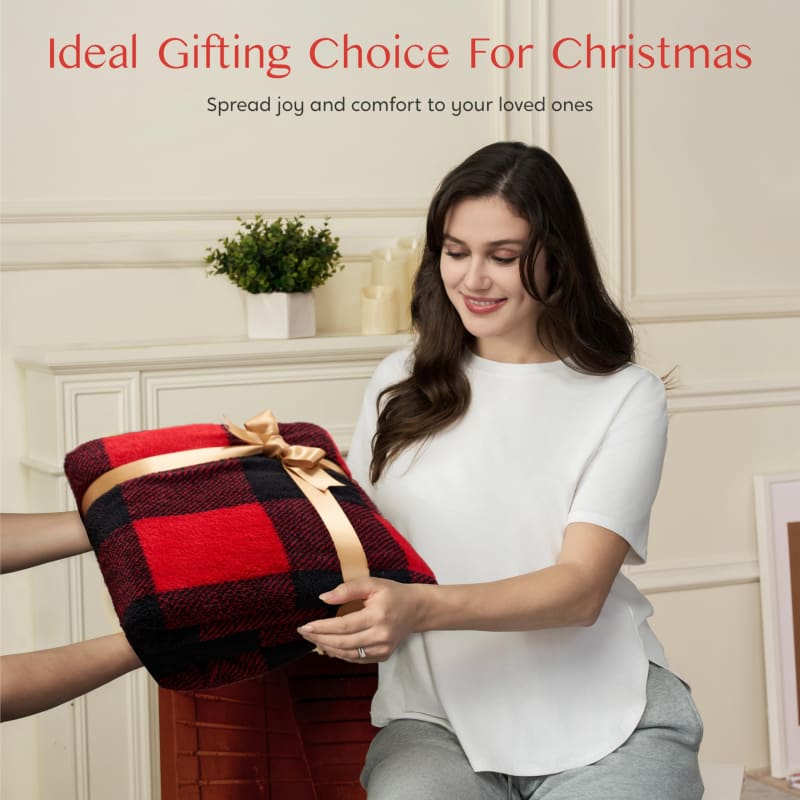 Red and black buffalo plaid blanket with a gold bow being given as a gift.