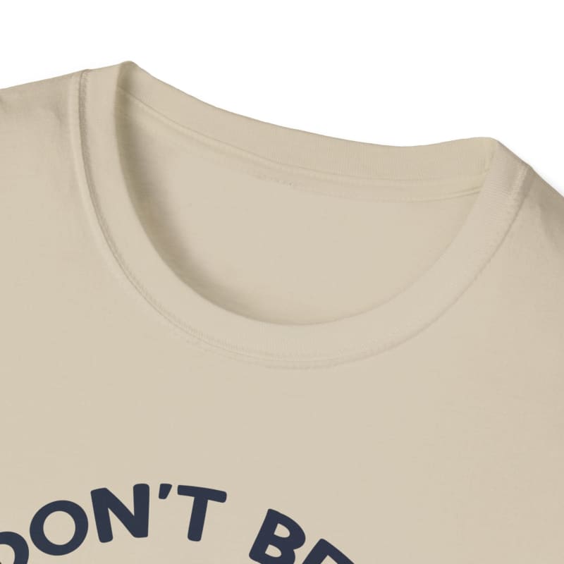 Beige crew neck t-shirt with partial dark text visible.