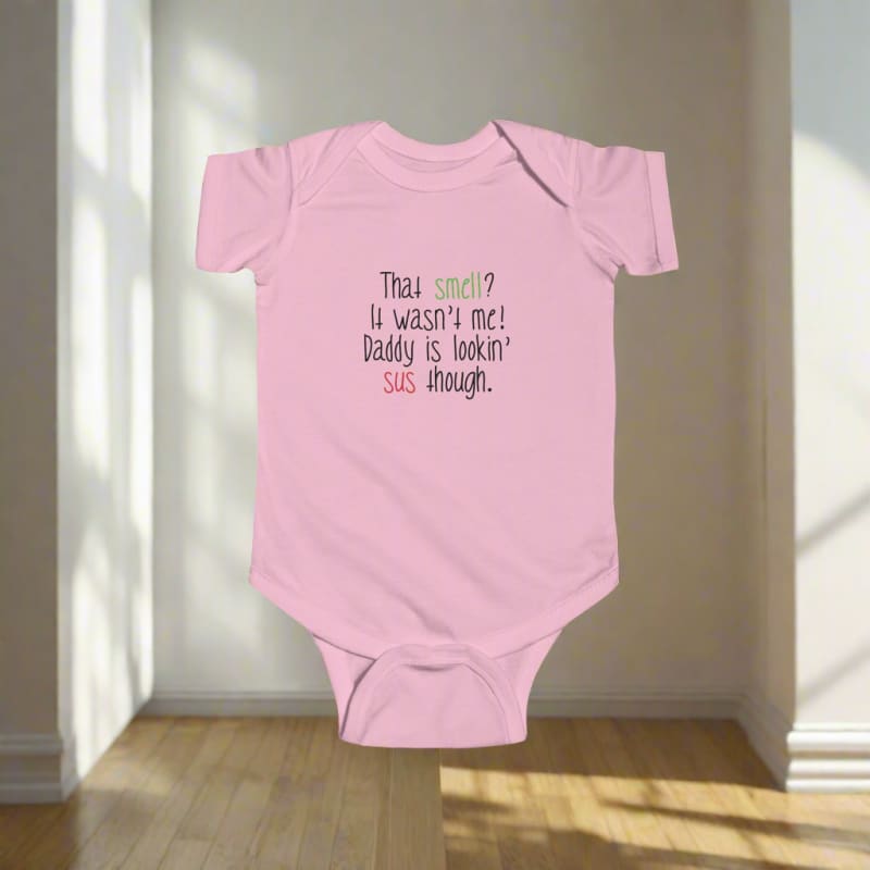 Pink baby onesie with humorous text printed on the front.