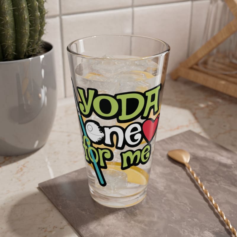 Glass with ’YODA one for me’ written on it, containing a beverage with ice.