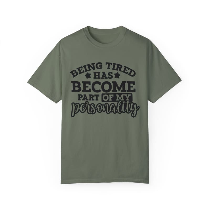 Olive green t-shirt with black text saying ’Being tired has become part of my personality’.