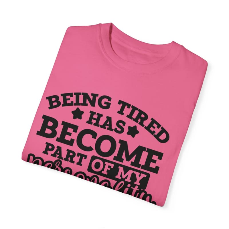 Pink t-shirt with black text saying ’Being tired has become part of my personality’.