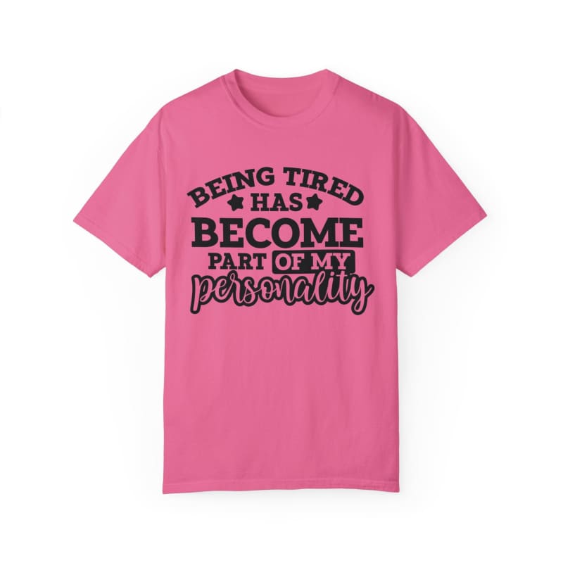 Pink t-shirt with black text saying ’Being tired has become part of my personality’.