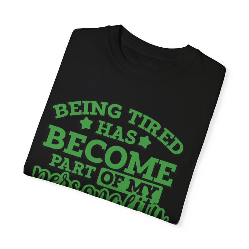 Black t-shirt with green text saying ’Being tired has become part of my personality’.