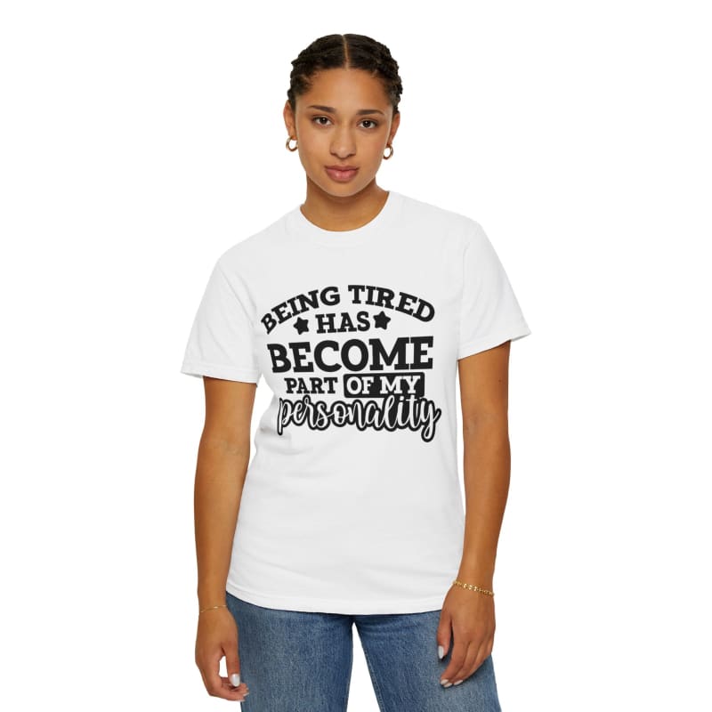 White t-shirt with black text saying ’Being tired has become part of my personality’.