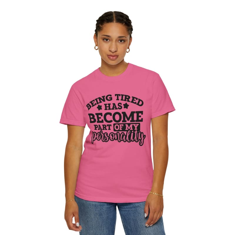 Pink t-shirt with black text saying ’Being tired has become part of my personality’.