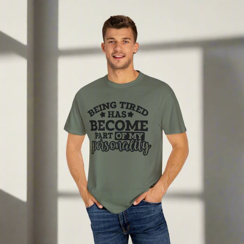 Green t-shirt with black text reading ’Being tired has become part of my personality’.