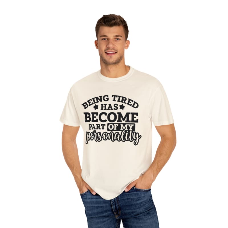 White t-shirt with black text saying ’BEING TIRED HAS BECOME PART OF MY PERSONALITY’.