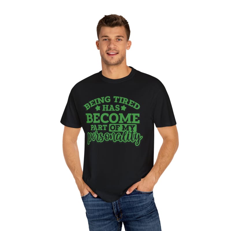 Black t-shirt with green text saying ’Being tired has become part of my personality’.