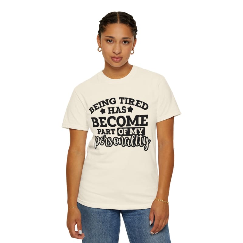 White t-shirt with black text saying ’BEING TIRED HAS BECOME PART OF MY PERSONALITY’.