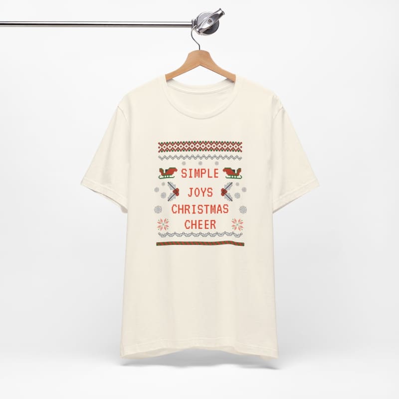 Cream-colored t-shirt with a festive ’Simple Christmas Cheer’ design featuring birds and snowflakes.