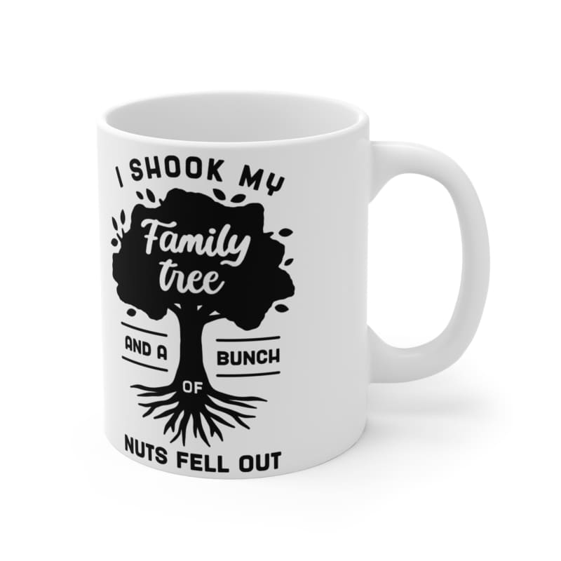 White ceramic mug with black text and a family tree design that reads ’I shook my family tree and a bunch of nuts fell out’