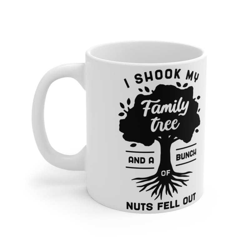 White ceramic mug featuring a black graphic design of a tree with humorous text about shaking a family tree.