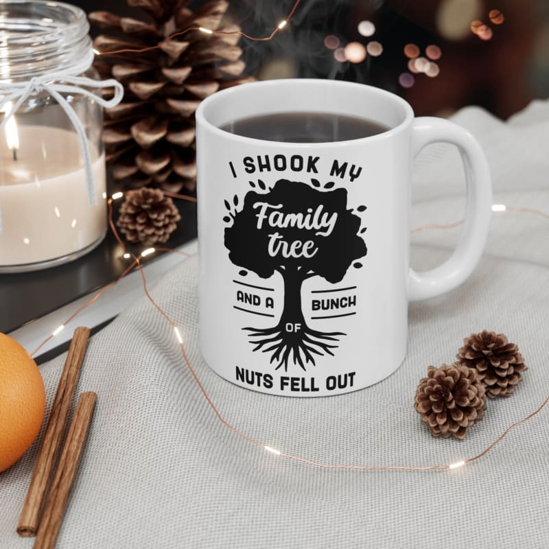 White coffee mug with text reading ’I shook my family tree and a bunch of nuts fell out’ alongside a tree design.