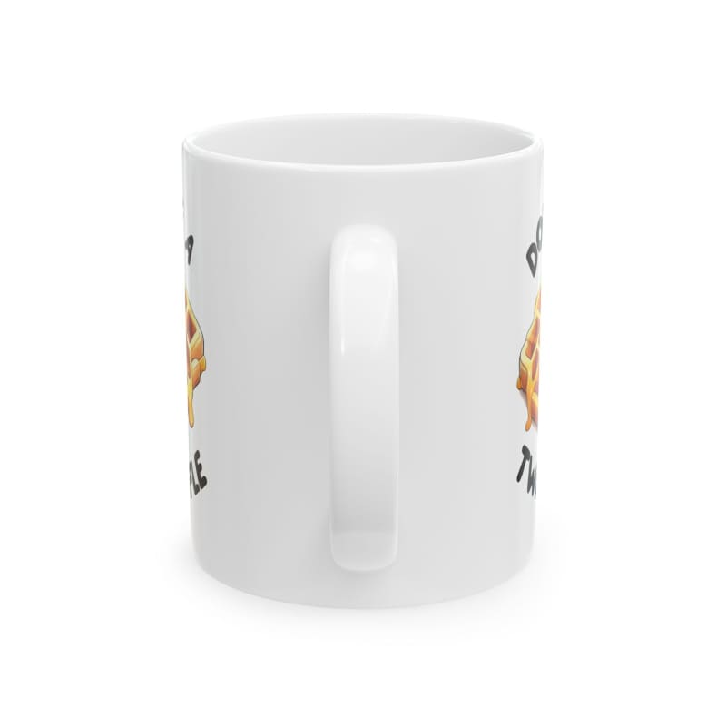 White ceramic mug with a cartoon graphic design on its side.