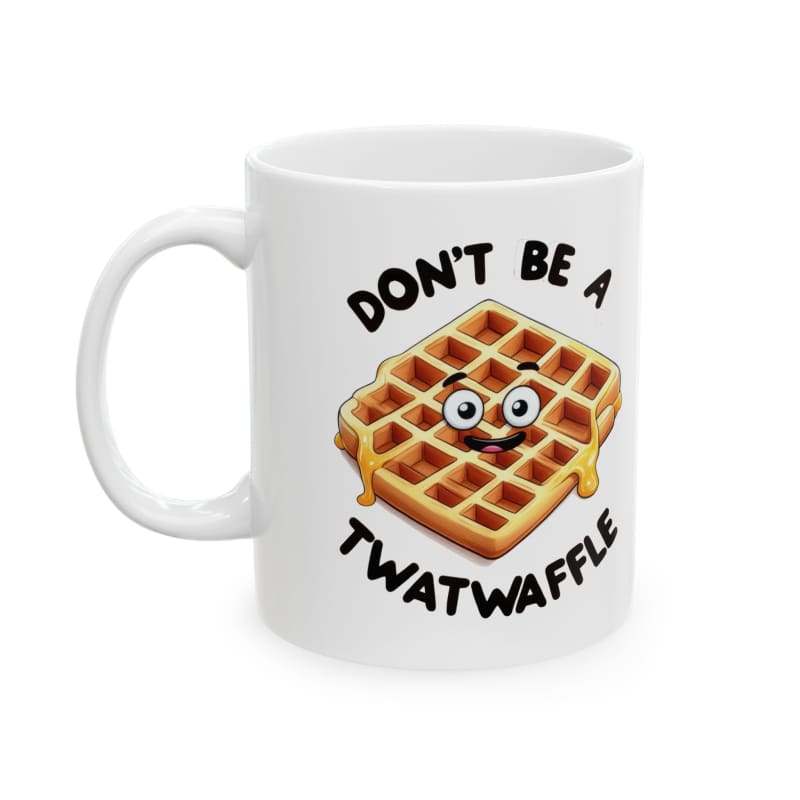 White coffee mug featuring a cartoon waffle design with googly eyes and text reading ’DON’T BE A TWATWAFFLE’