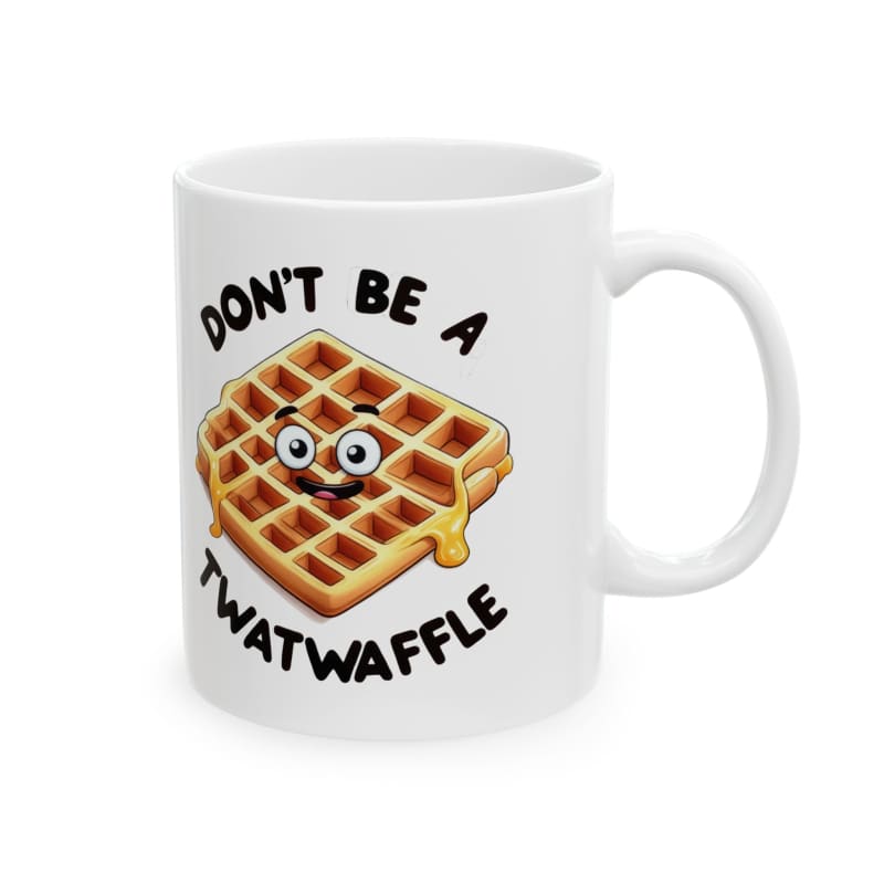 White coffee mug with a cartoon waffle design and text saying ’DON’T BE A TWATWAFFLE’