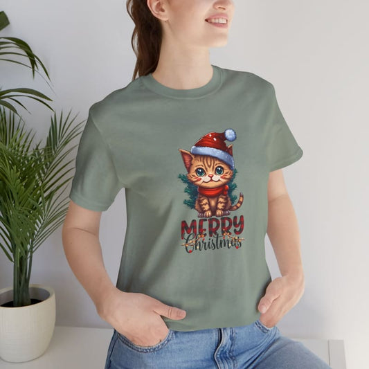 Sage green t-shirt featuring a cartoon kitten wearing a Santa hat with ’Merry Christmas’ text.