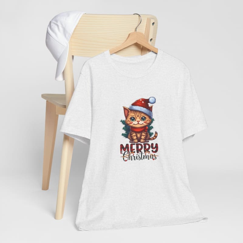 White t-shirt featuring a festive cartoon cat wearing a Santa hat with ’Merry Christmas’ text.