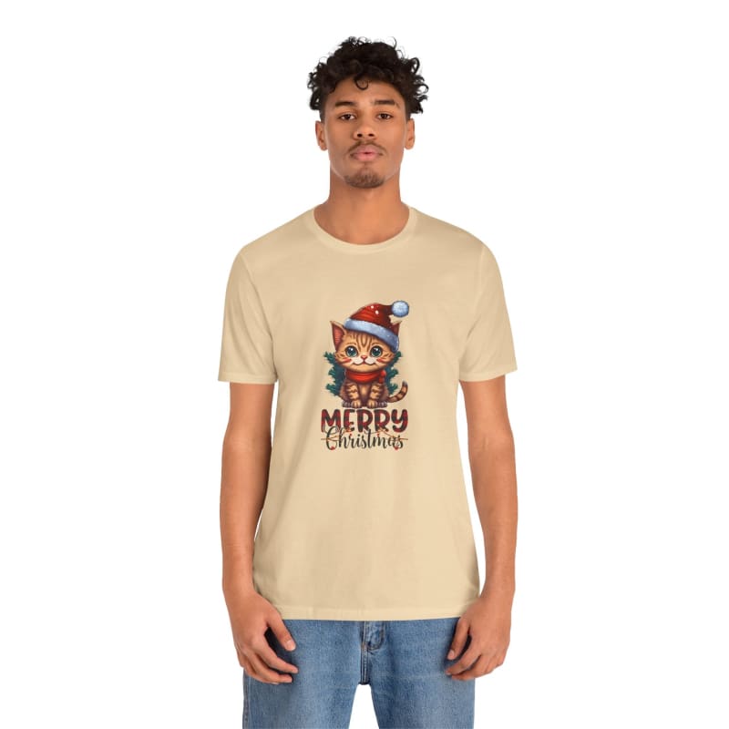 Beige t-shirt featuring a cartoon cat wearing a Santa hat with ’Merry Christmas’ text.