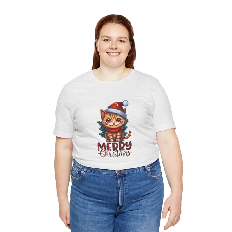 White t-shirt with a festive cat wearing a Santa hat design and ’Merry Christmas’ text paired with blue jeans.