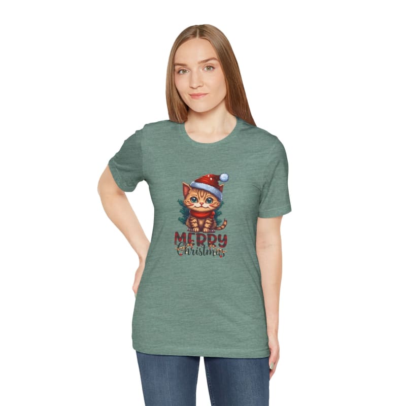 Sage green t-shirt featuring a cartoon cat wearing a Santa hat with ’Merry Christmas’ text.