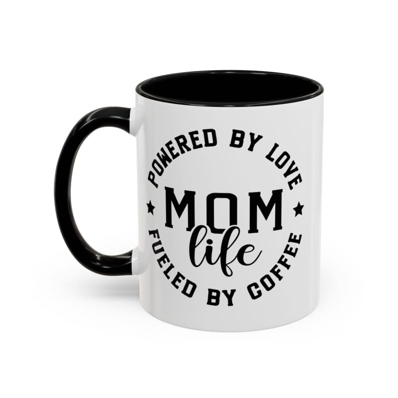 White coffee mug with black interior and handle featuring ’MOM LIFE POWERED BY LOVE FUELED BY COFFEE’ text.