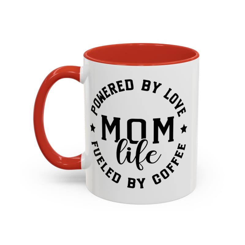 White coffee mug with red handle and interior featuring black text that reads ’POWERED BY LOVE MOM LIFE FUELED BY COFFEE’