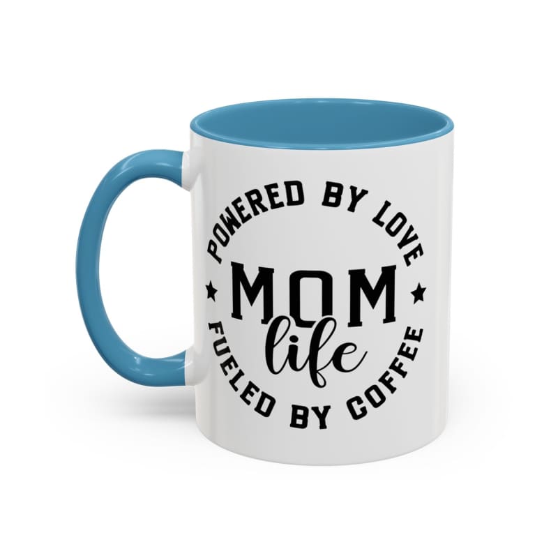 White coffee mug with blue handle and rim featuring black text that reads ’POWERED BY LOVE MOM LIFE FUELED BY COFFEE’