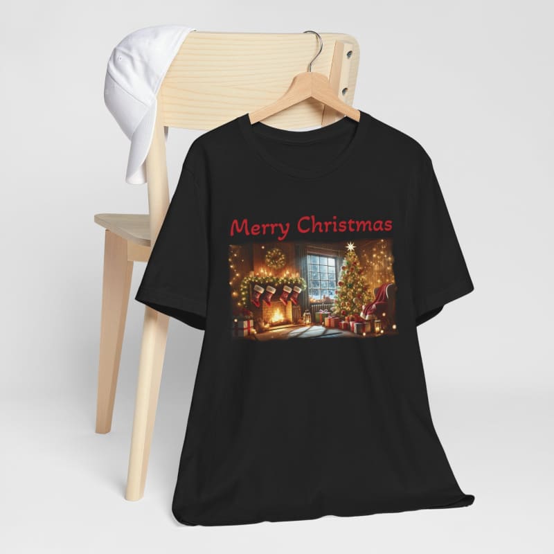 Black t-shirt with a festive ’Merry Christmas’ design featuring a cozy holiday scene with Christmas trees and lights.