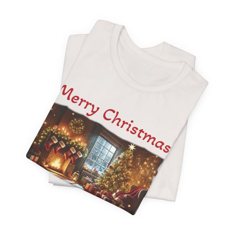 White t-shirt with a ’Merry Christmas’ design featuring a cozy holiday scene with a decorated tree and fireplace.