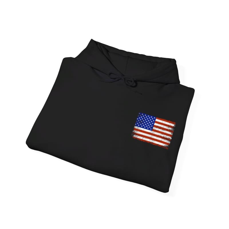 Black folded shirt with an American flag patch on the chest.