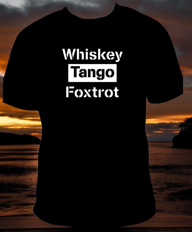 Black t-shirt with white text reading ’Whiskey Tango Foxtrot’ against a sunset background.